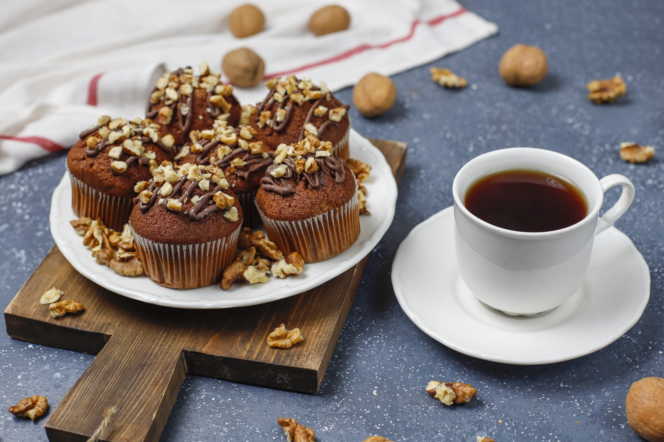 chocolate walnut muffins with coffee cup with walnuts dark surface scaled